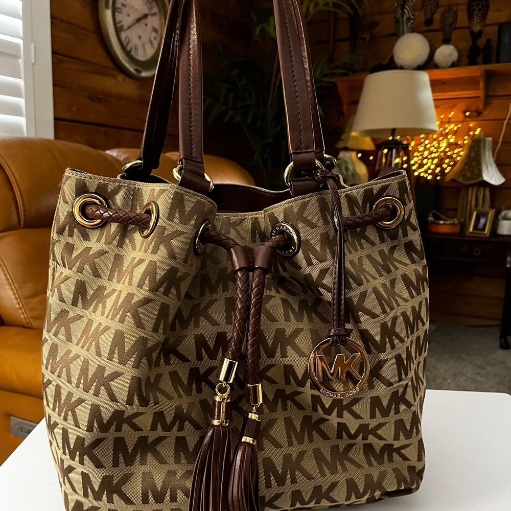 Michael Kors Brown MK Logo Drawstring Tote with Tassel Charm  15” x 12” x 5”.